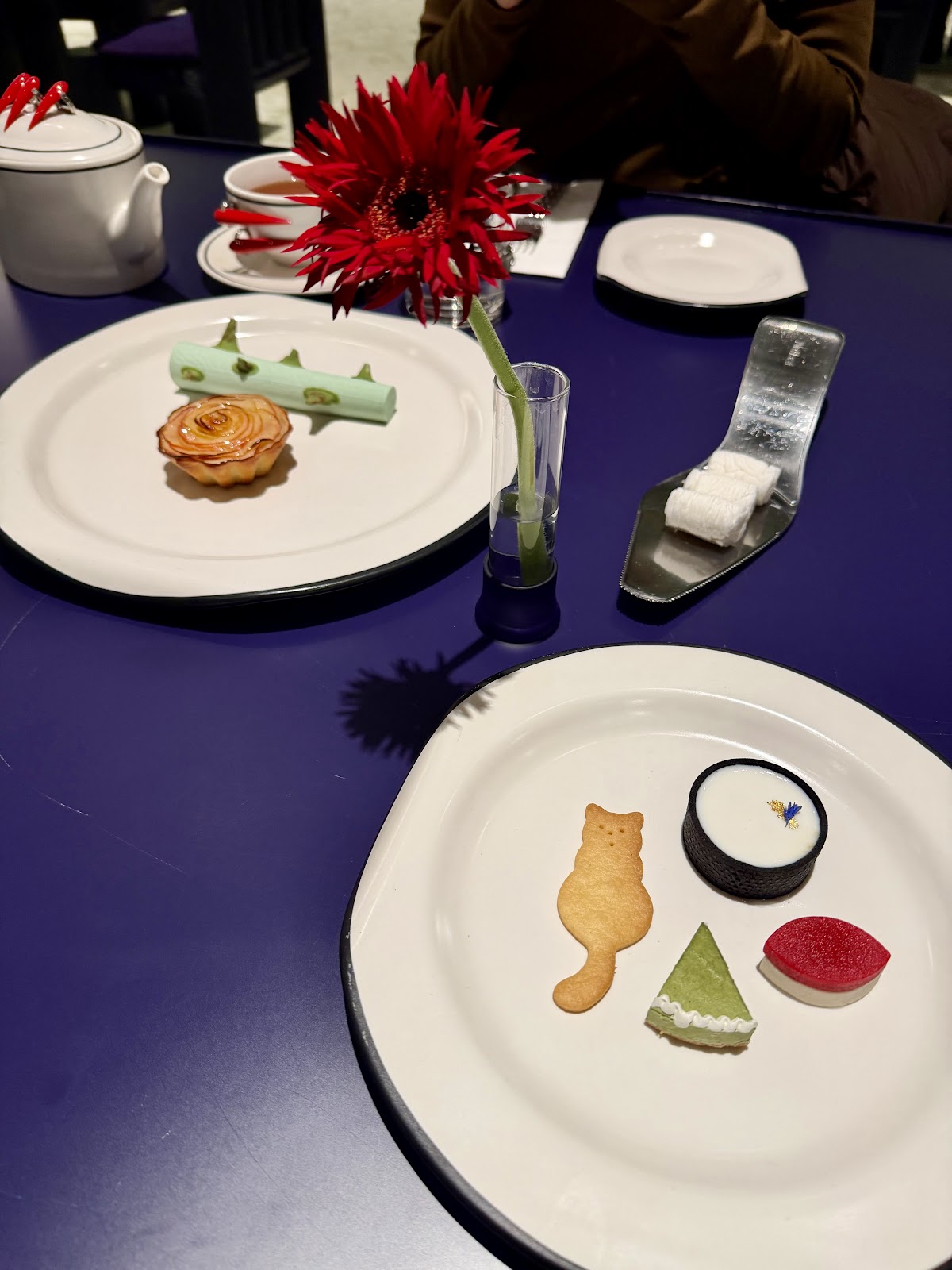 NUDAKE artfully plated desserts — edible art on deep blue table surfaces